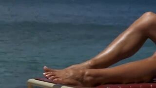 Pamela Anderson sunbathing in a skimpy bikini from "Baywatch: Hawaiian Wedding"